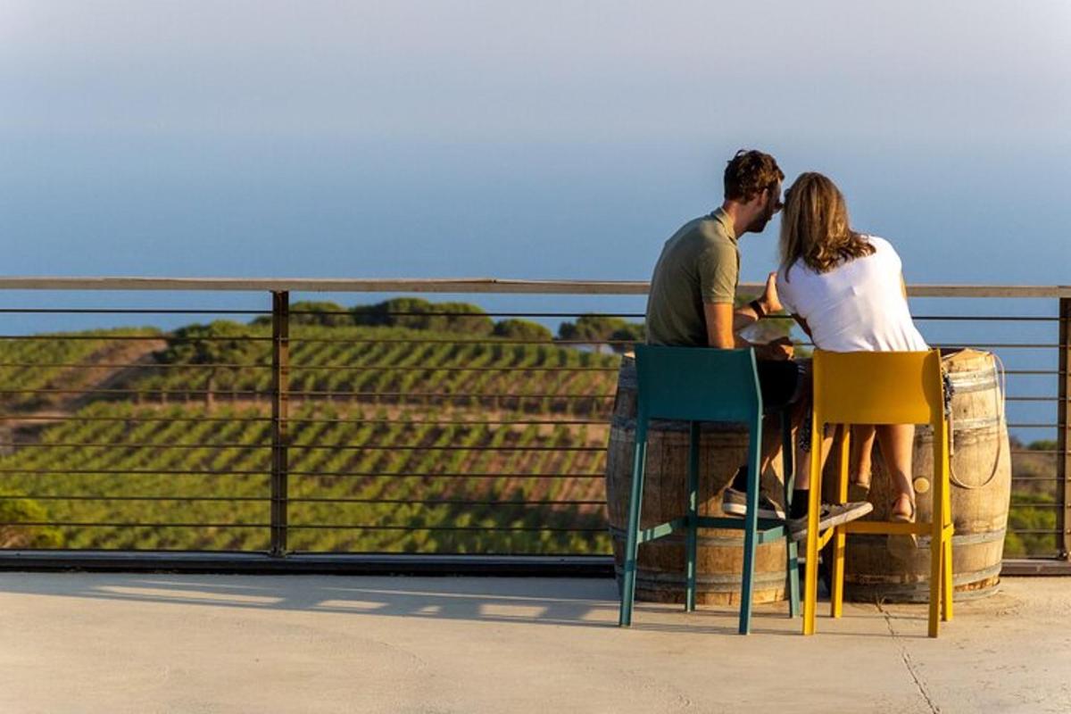 a man and woman sitting at a table looking at the view