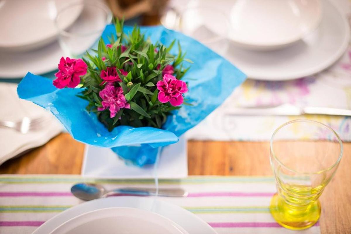 un tavolo con un vaso con fiori rosa sopra