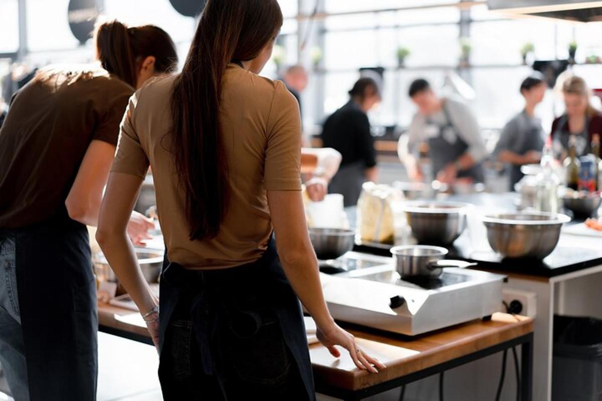 a woman standing in a kitchen preparing food