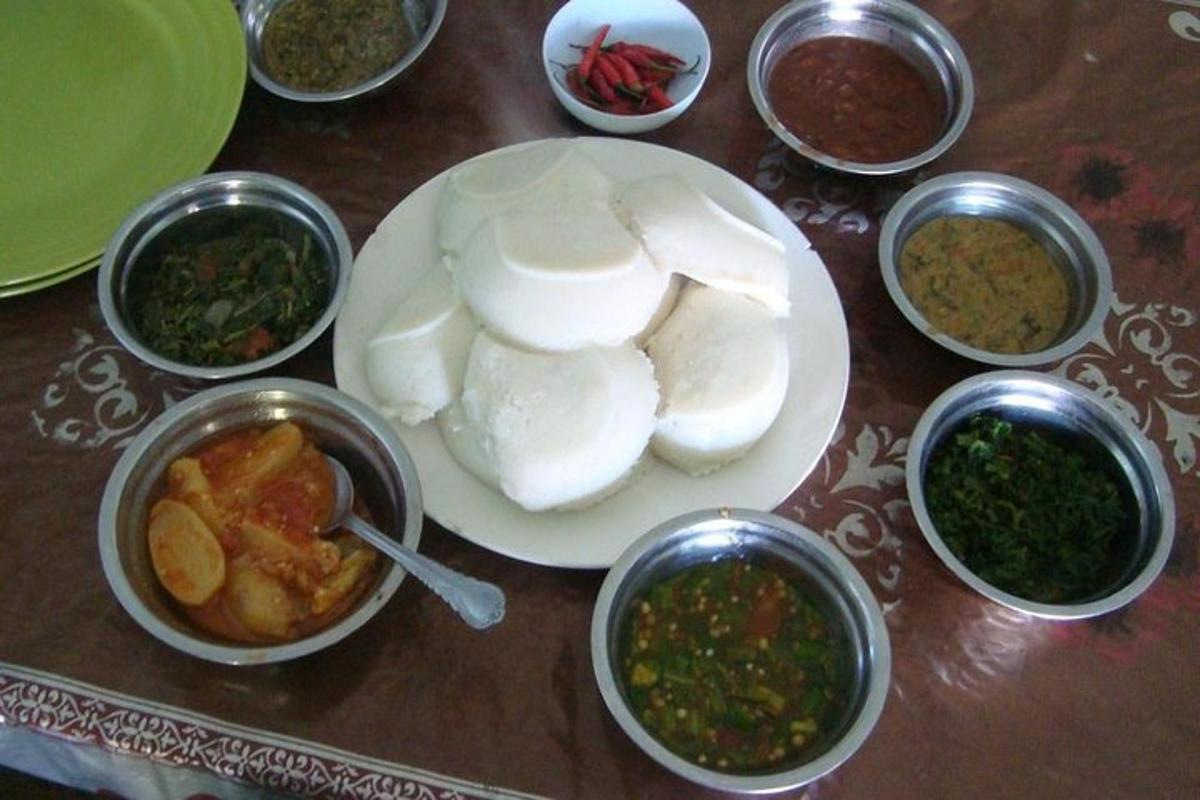 a table with a plate of food and bowls of food