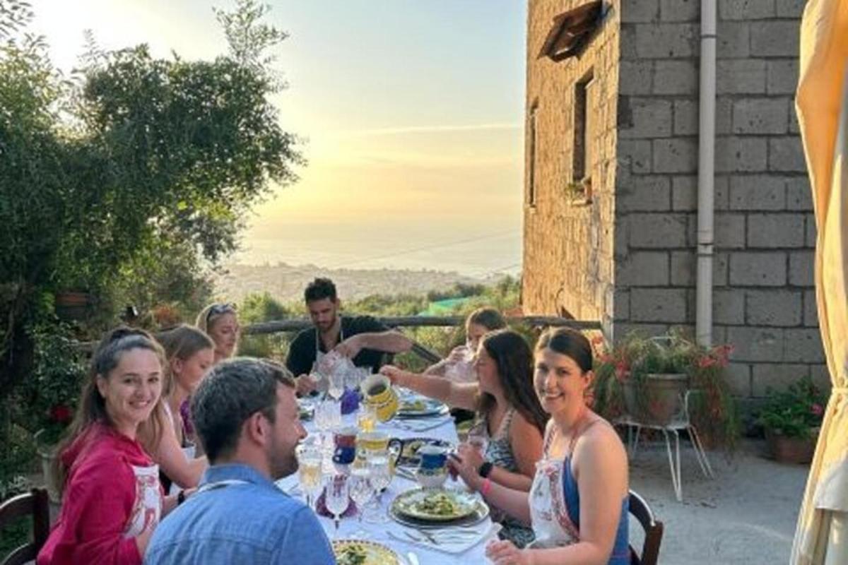 μια ομάδα ανθρώπων που κάθονται σε ένα τραπέζι τρώγοντας