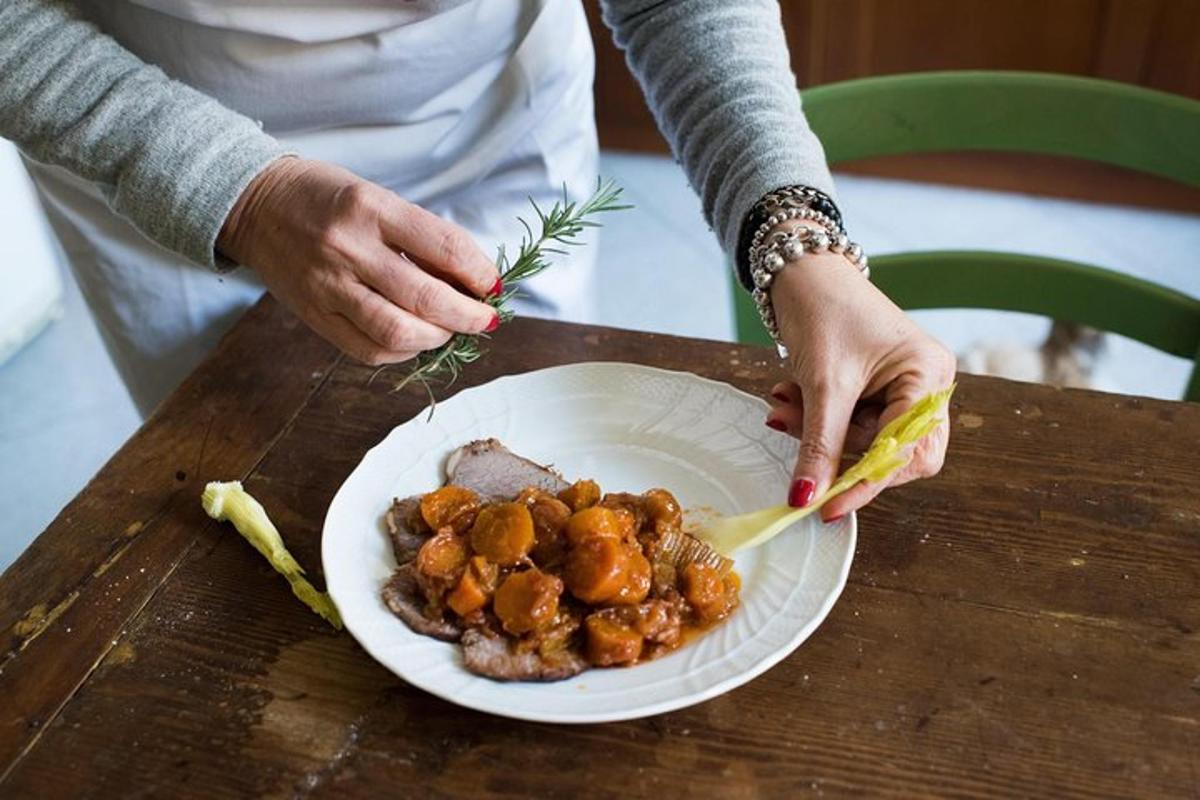 a person holding a plate of food on a table