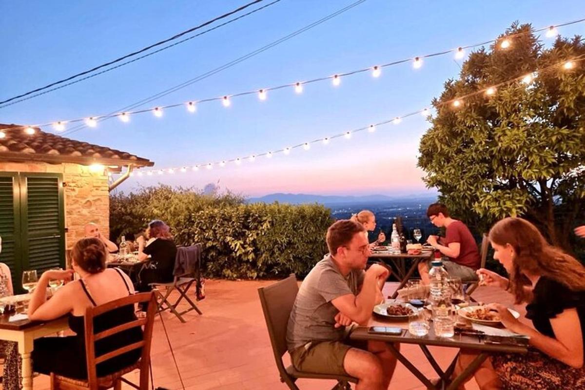 a group of people sitting at tables on a patio