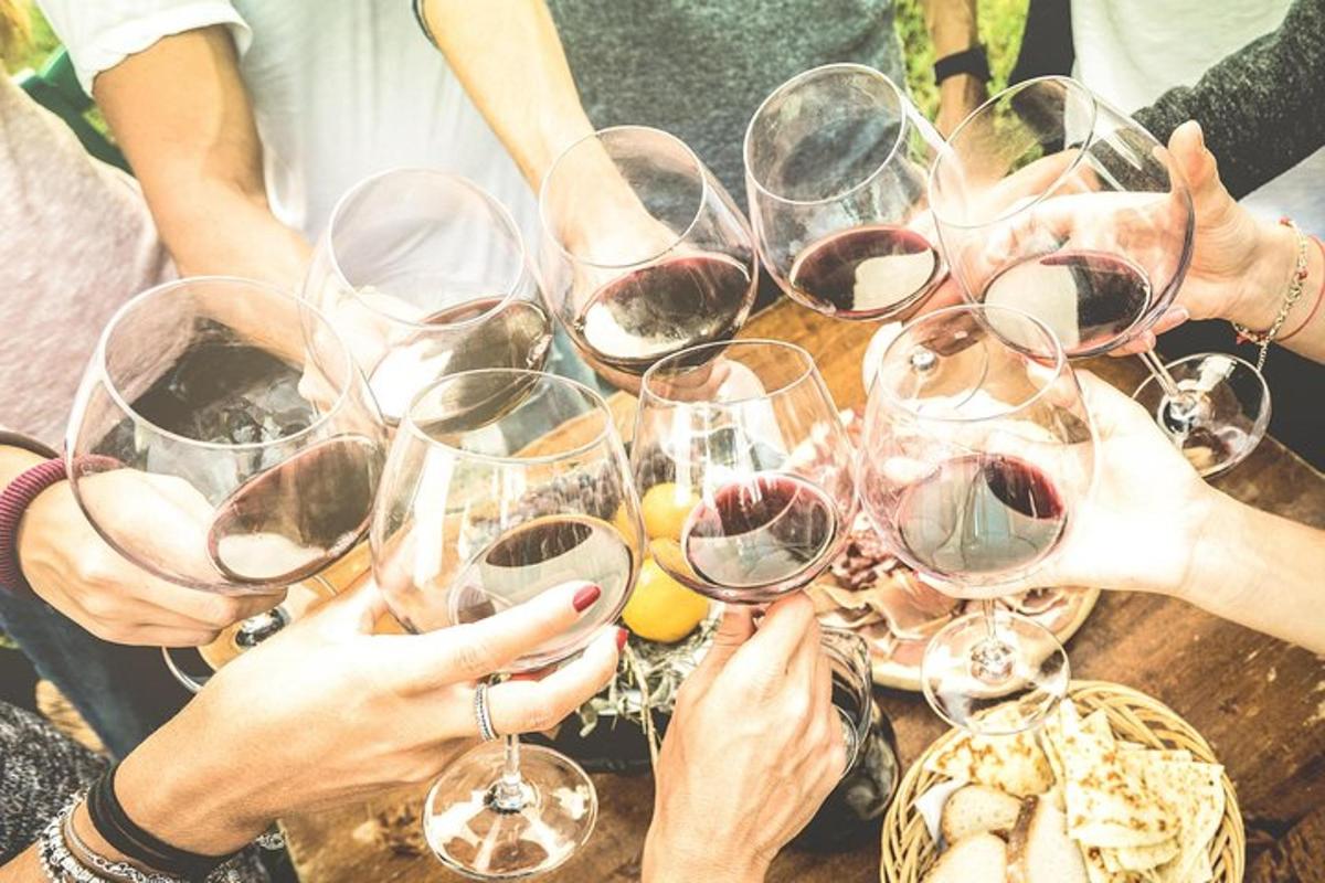 a group of people holding wine glasses on a table