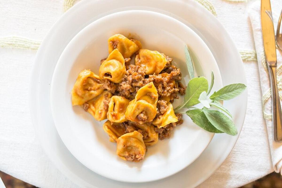 a plate of pasta with meat and sauce