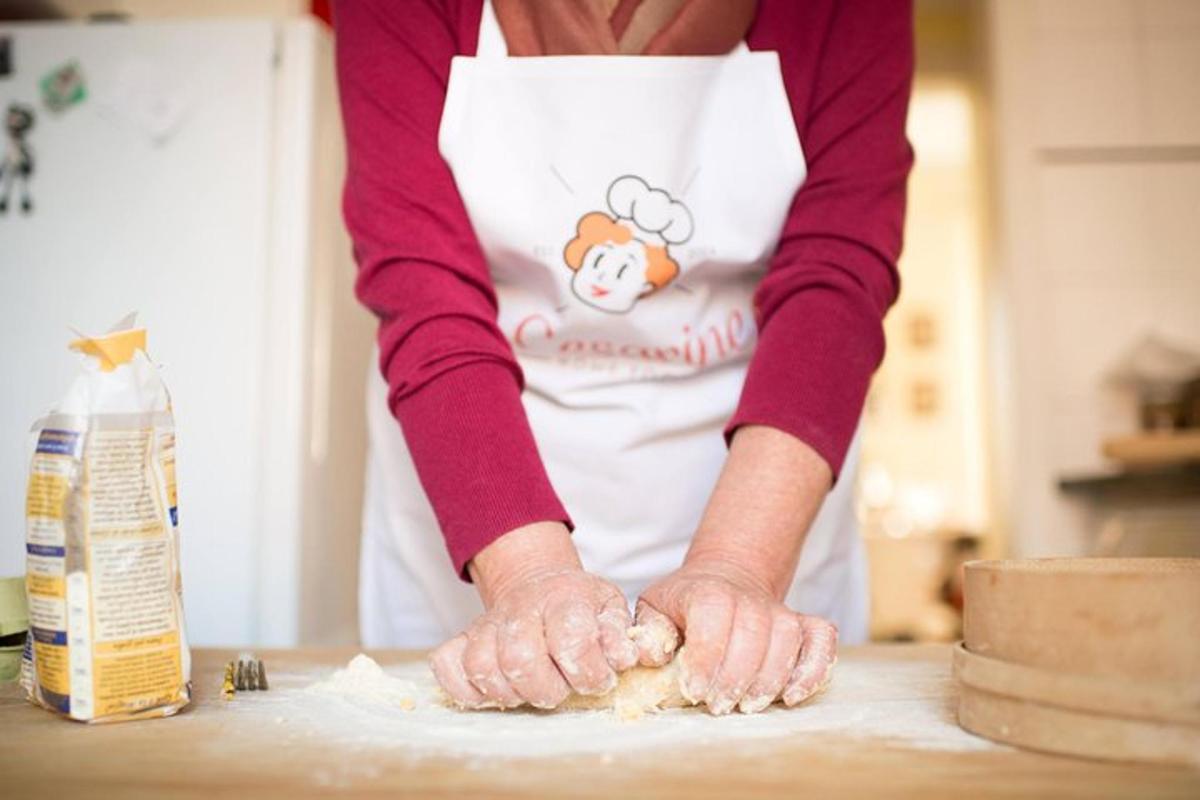 una persona con un grembiule che impasta su un tavolo