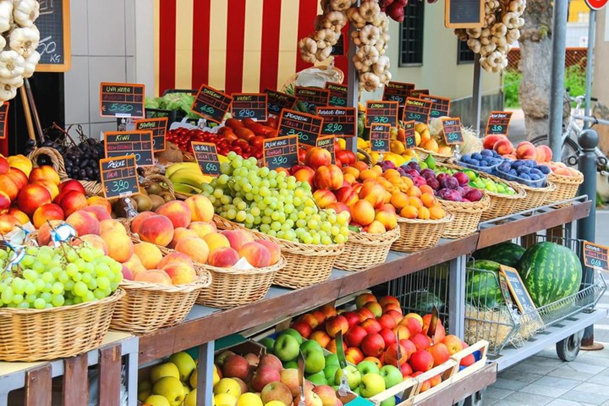a market with baskets of fruits and vegetables on display