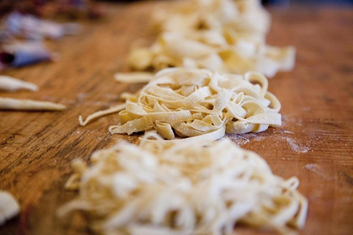 a pile of pasta on a wooden cutting board
