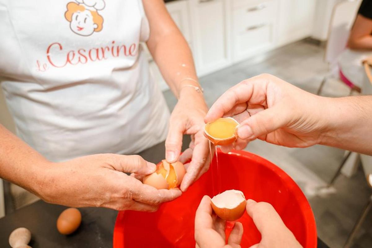 a group of people holding eggs in a red bowl