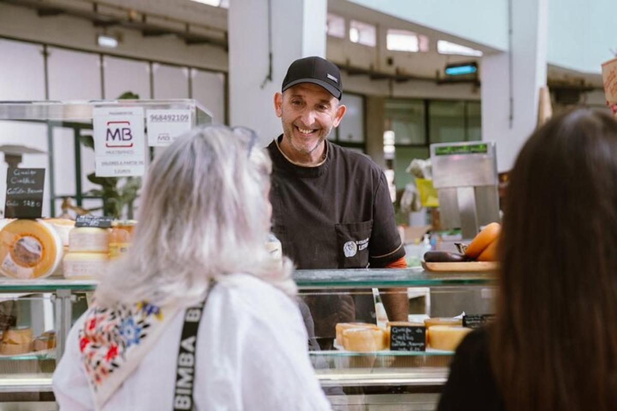 a man standing behind a counter with a woman