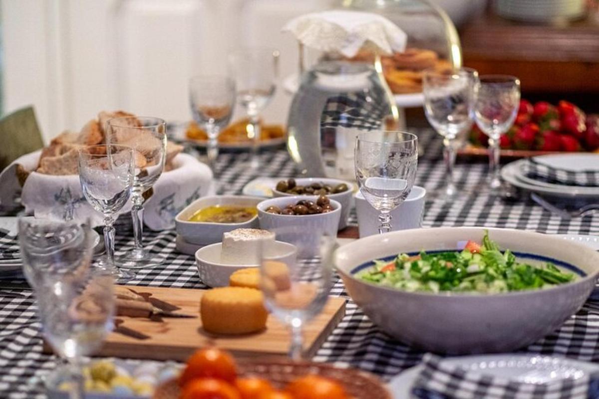a table topped with bowls of food and wine glasses