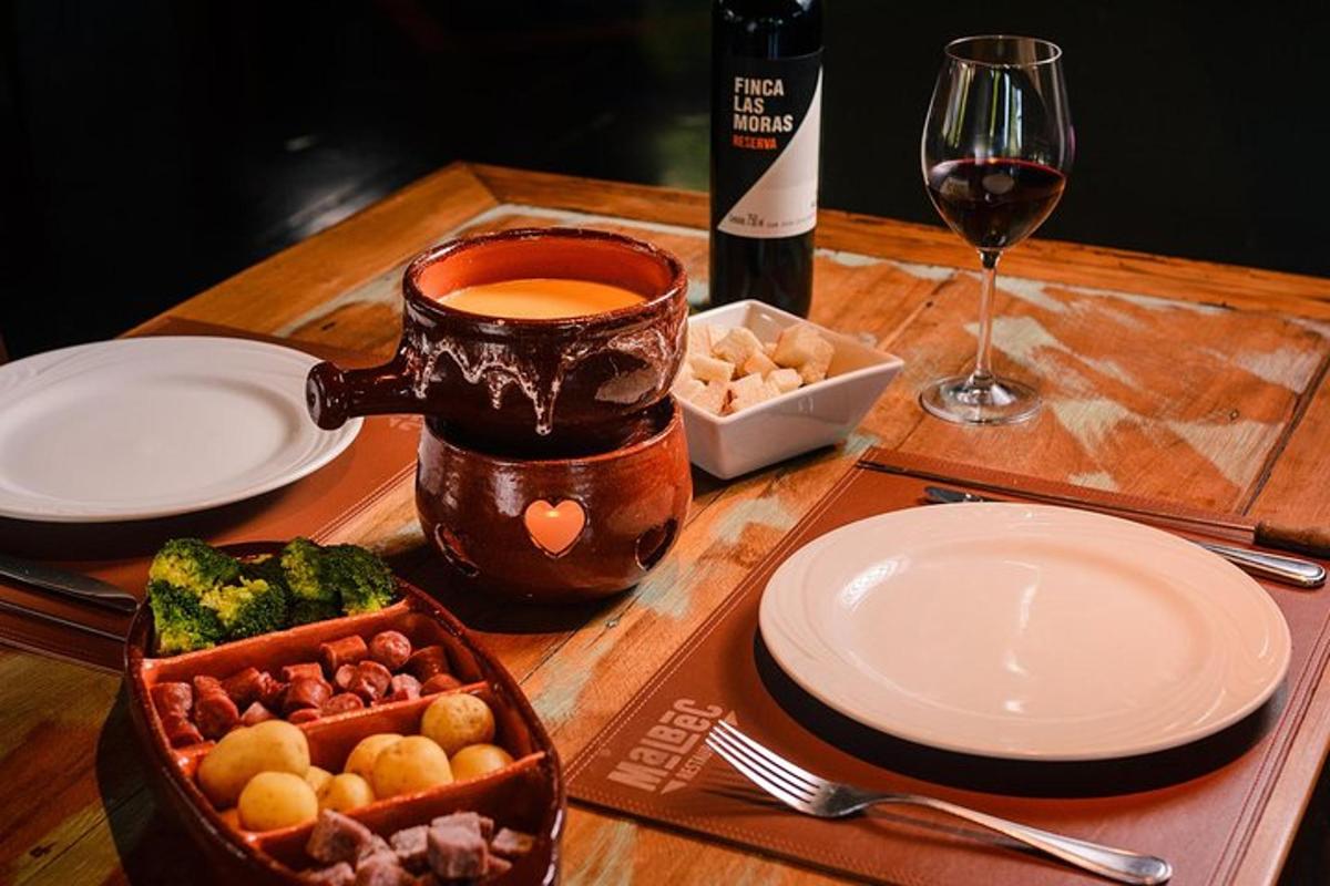 a wooden table topped with plates and a bottle of wine