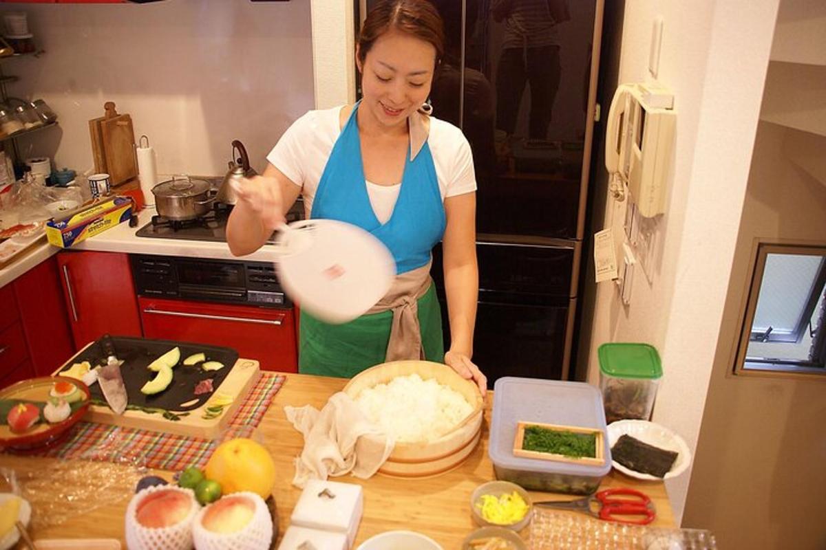a woman standing in a kitchen preparing food