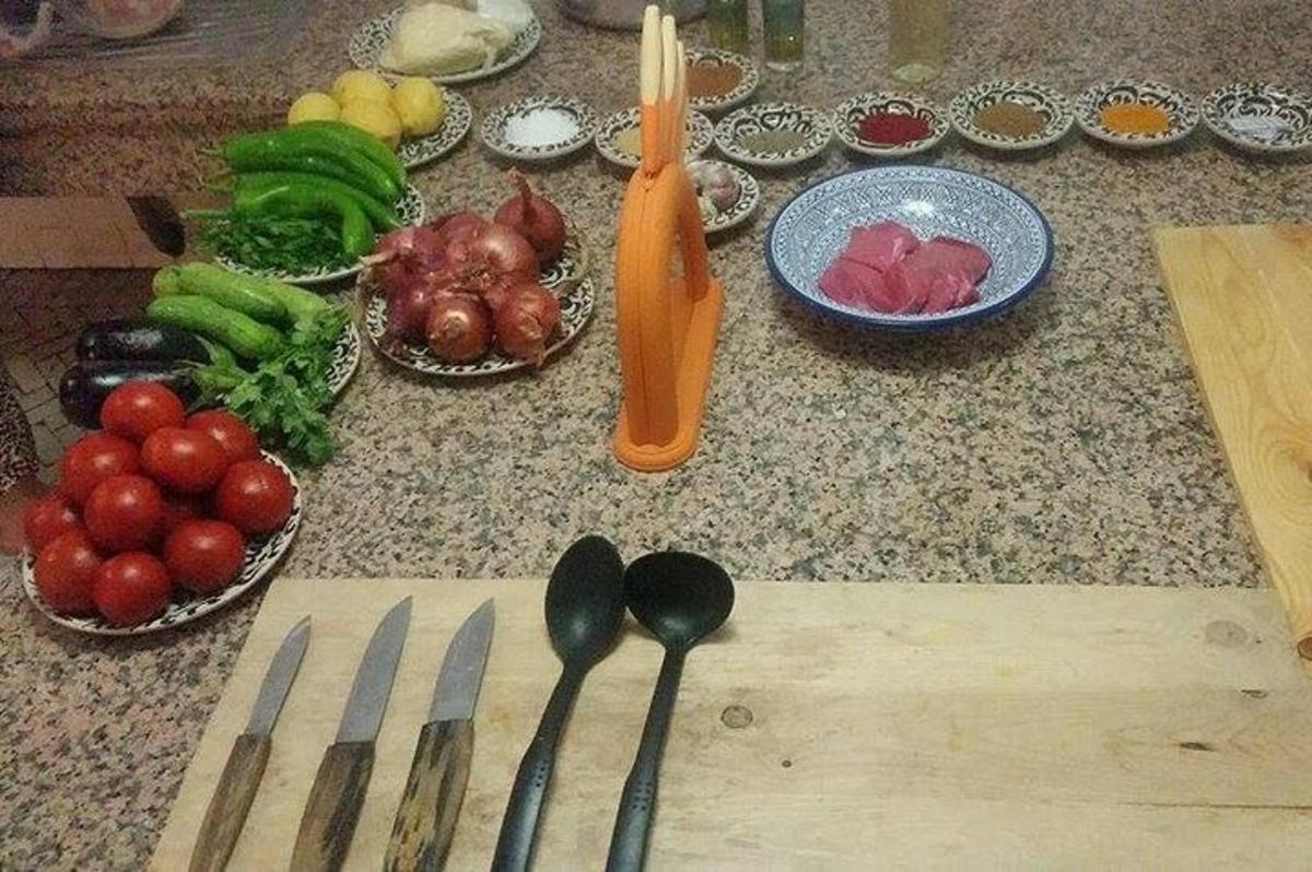 a bunch of vegetables on a counter with spoons