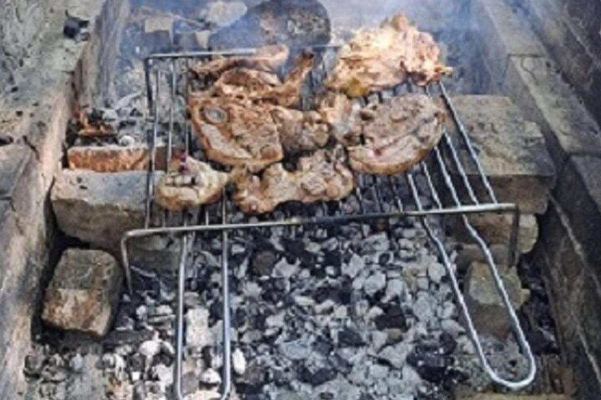 μια σχάρα με κρέας που ψήνεται από πάνω