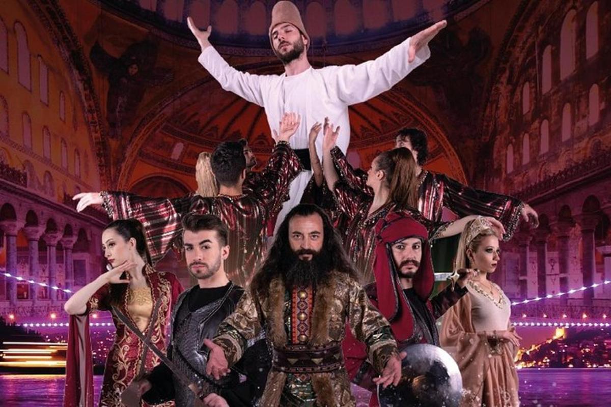 μια ομάδα ηθοποιών σε μια σκηνή με έναν άνδρα να πηδάει στον αέρα