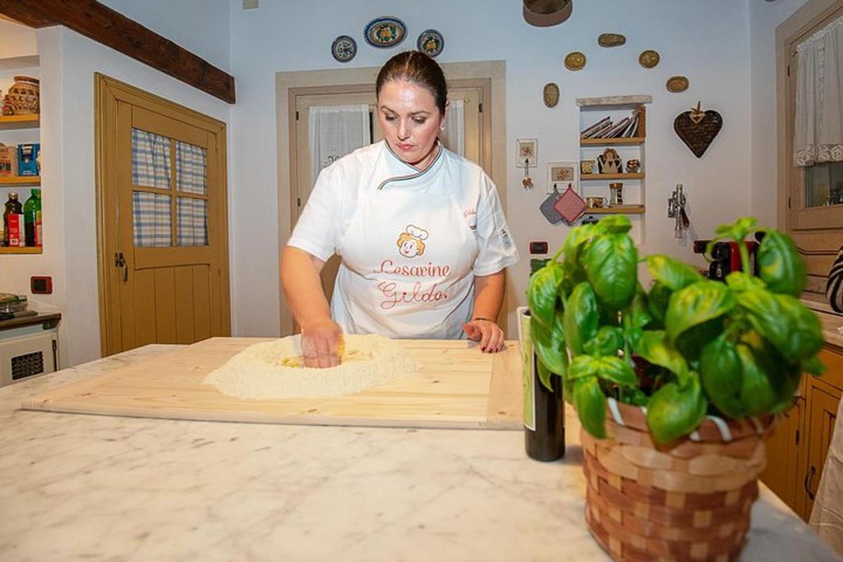 a woman in a kitchen preparing food on a cutting board