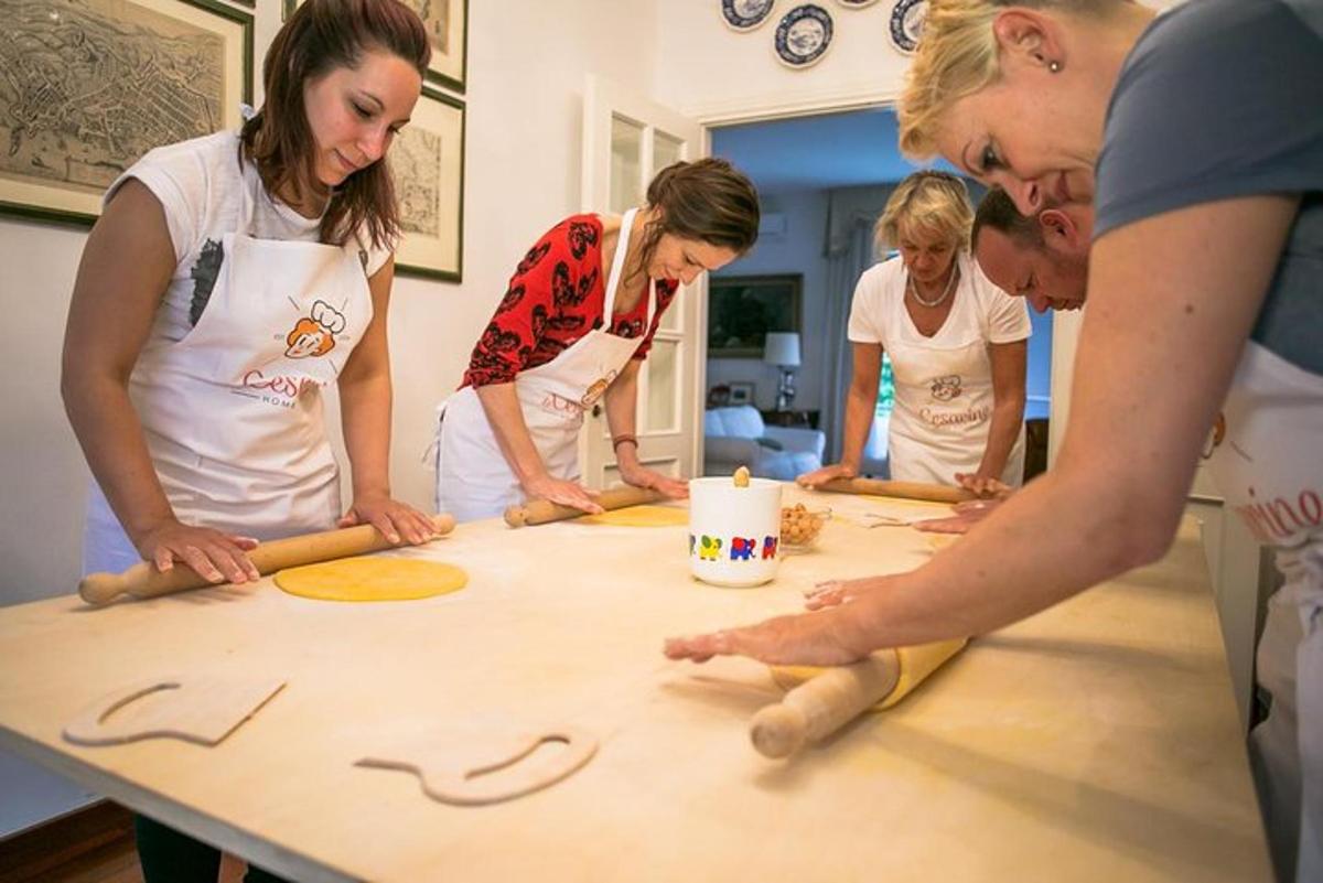 a group of people standing around a table with dough