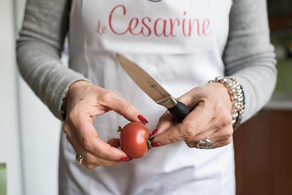 a woman holding a knife and a tomato