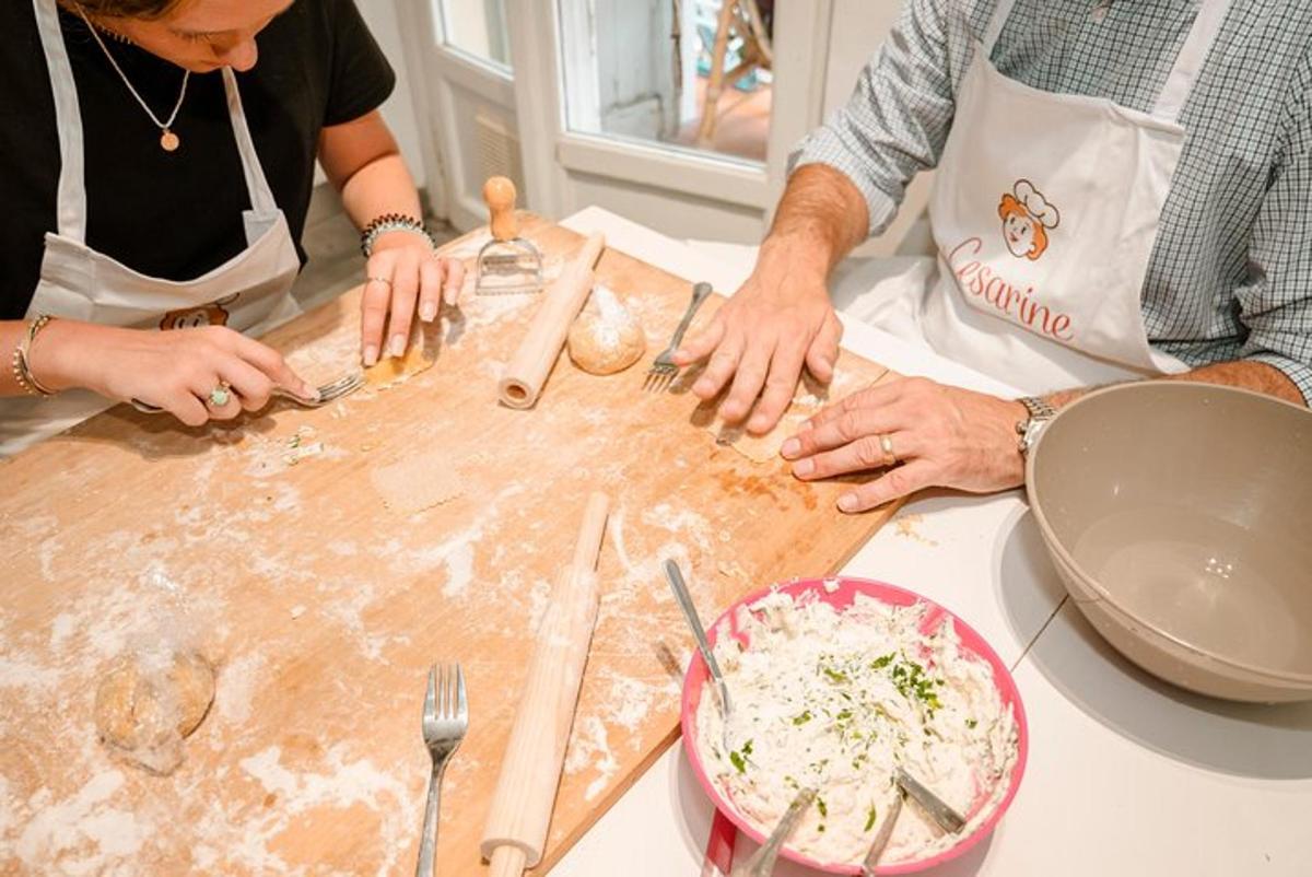 a group of people preparing food on a cutting board