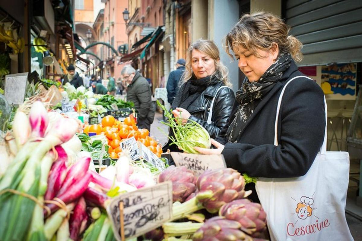 two women are looking at vegetables in a market
