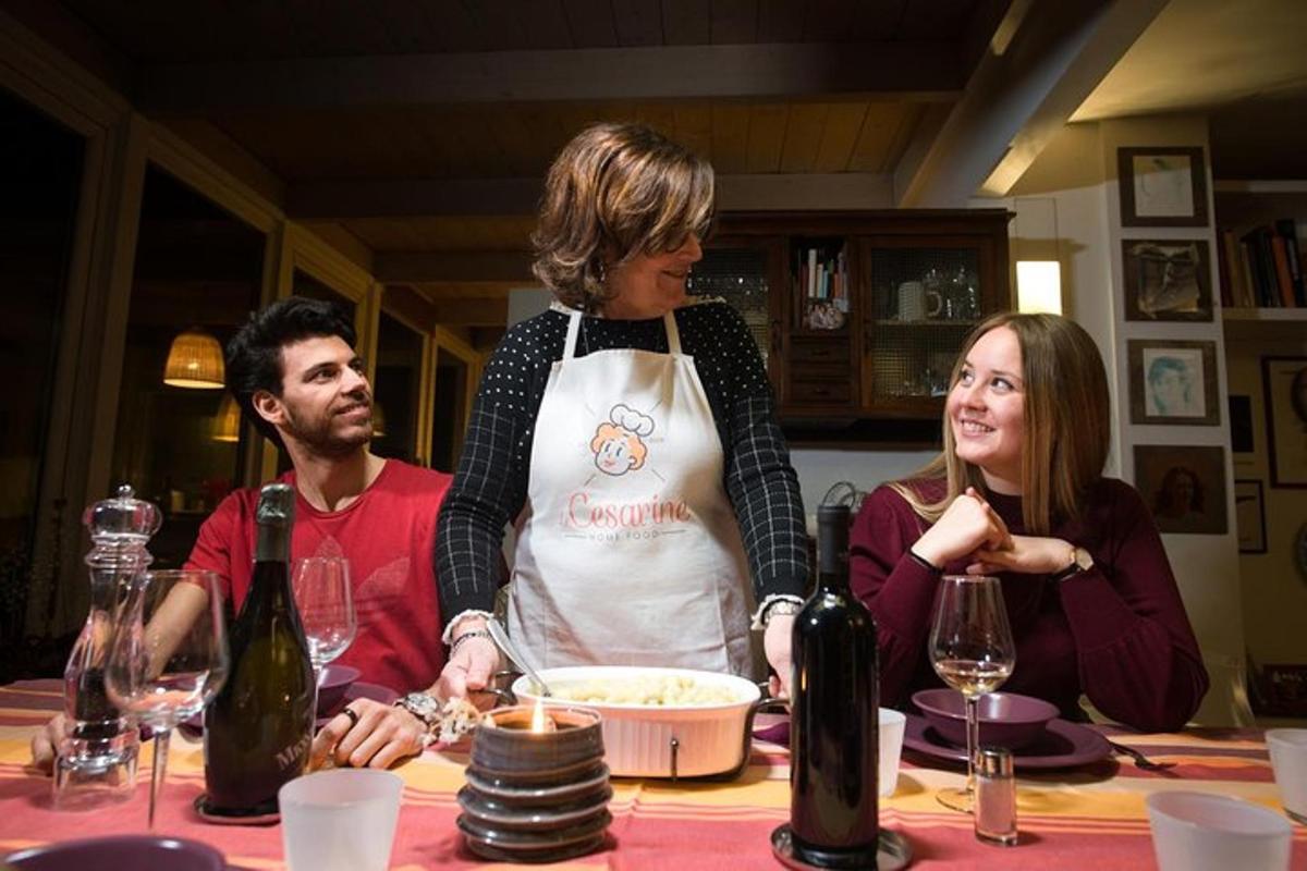 a woman in an apron standing at a table