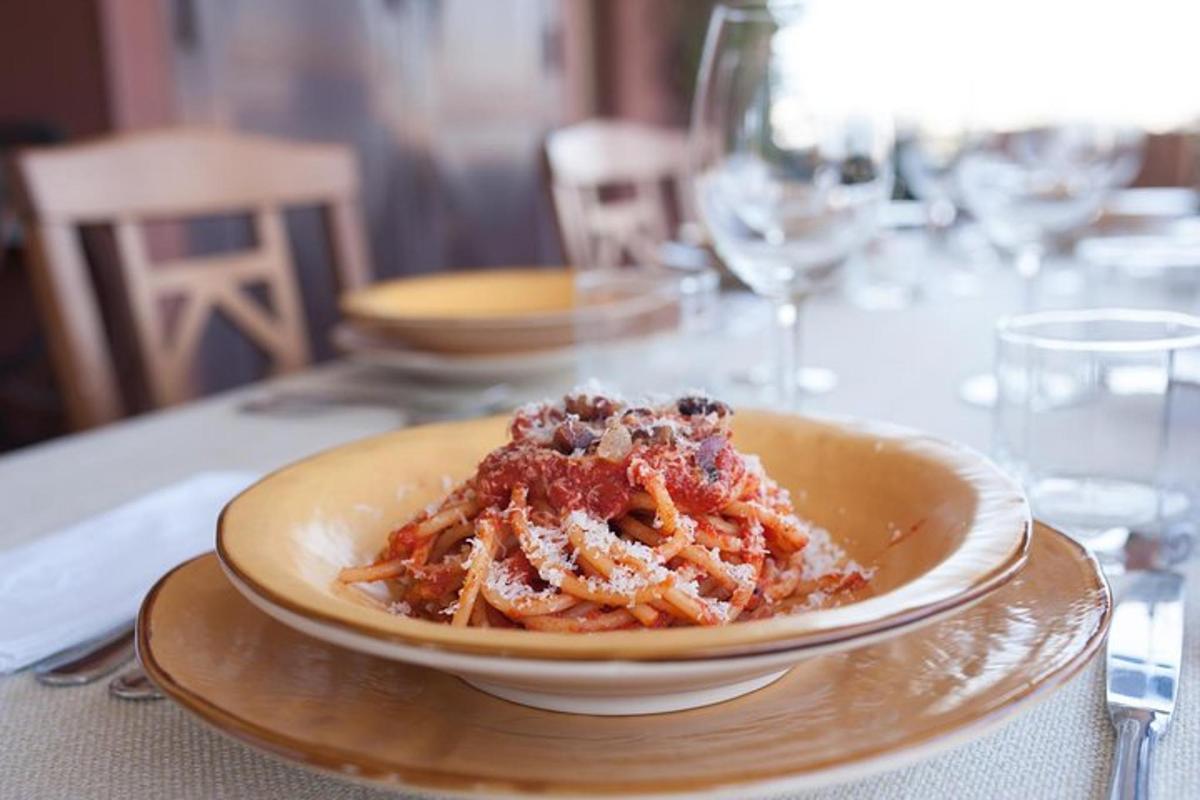 a bowl of pasta on a plate on a table