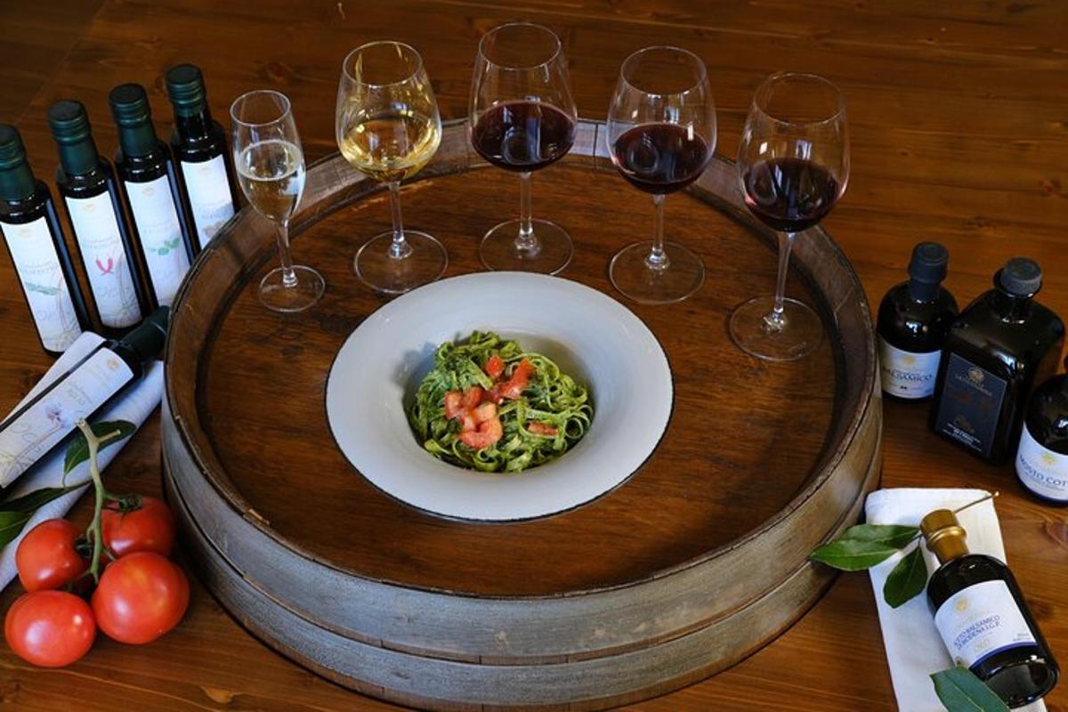 a table with a plate of broccoli and wine glasses