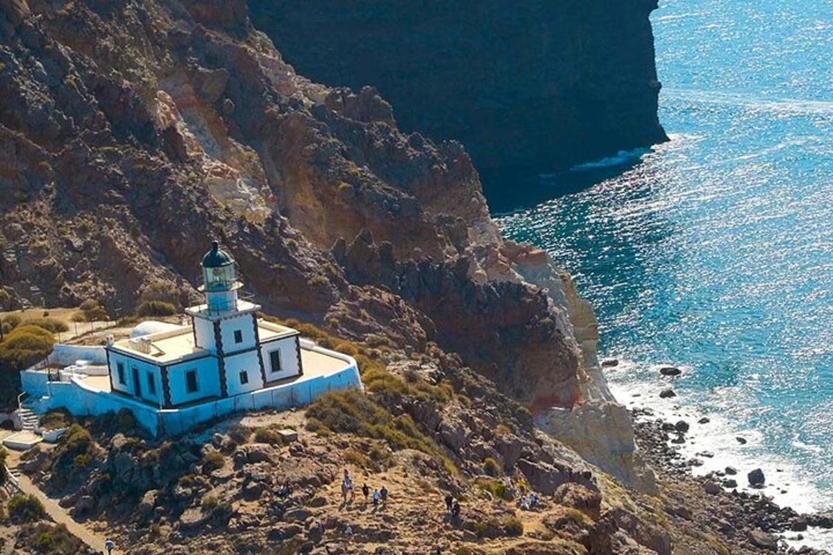 a lighthouse on a cliff next to the ocean