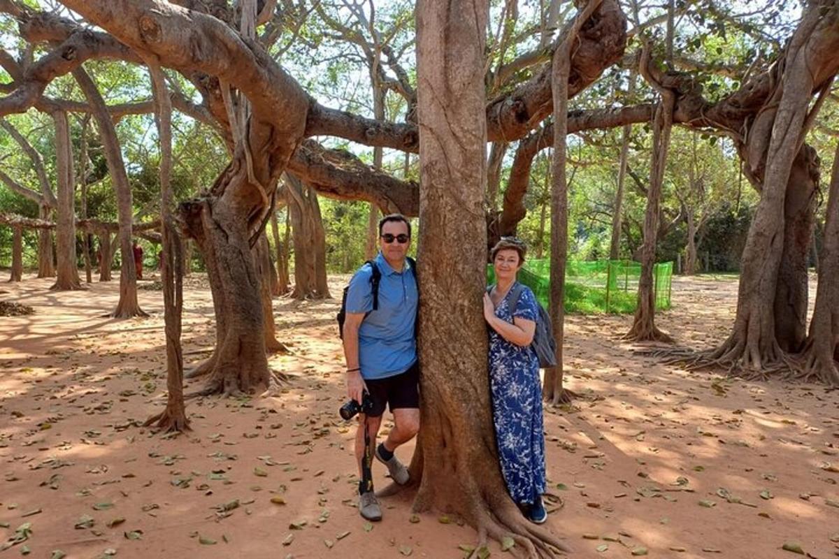 a man and a woman standing next to a tree