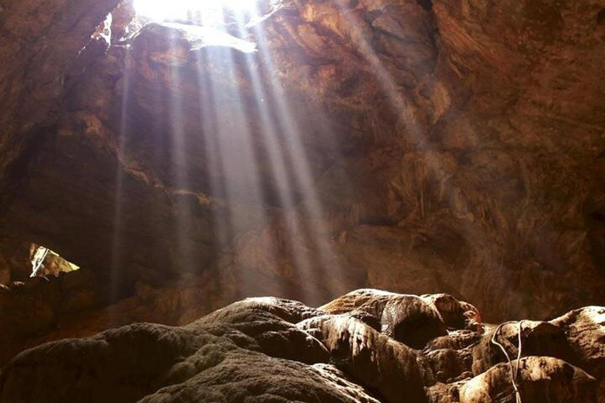 a cave with the sun shining inside of it
