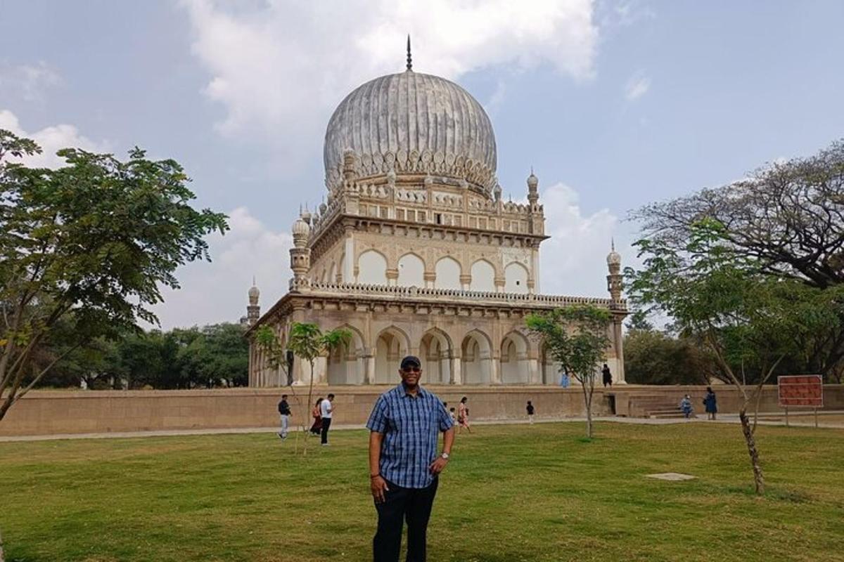 a man standing in front of a large building