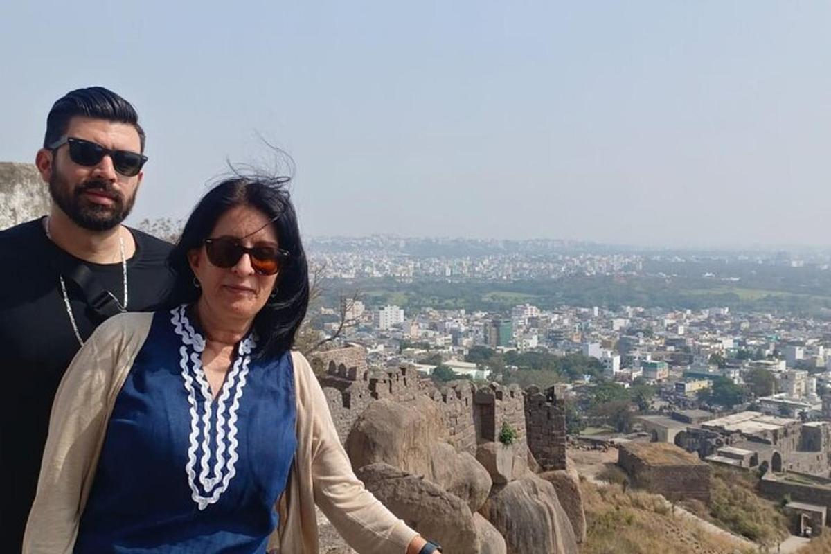 a man and a woman standing on top of a mountain