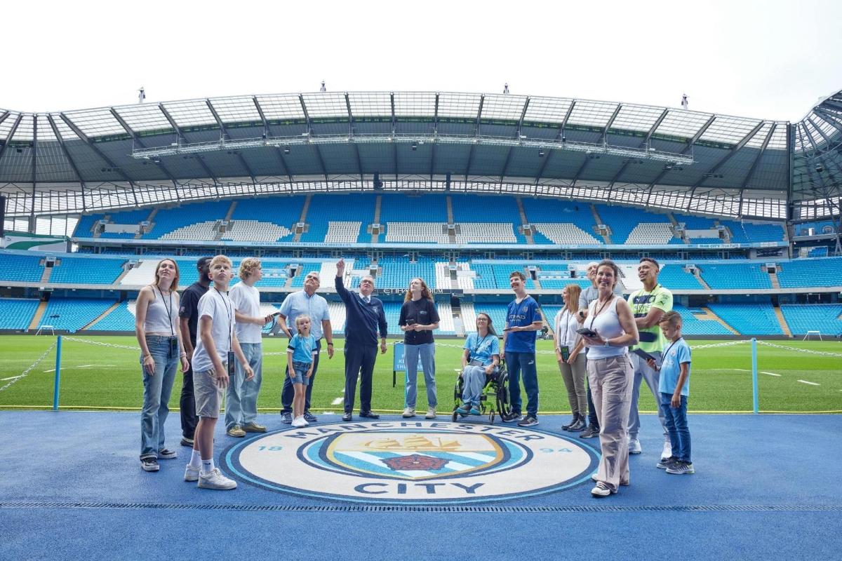 a group of people standing in front of a stadium