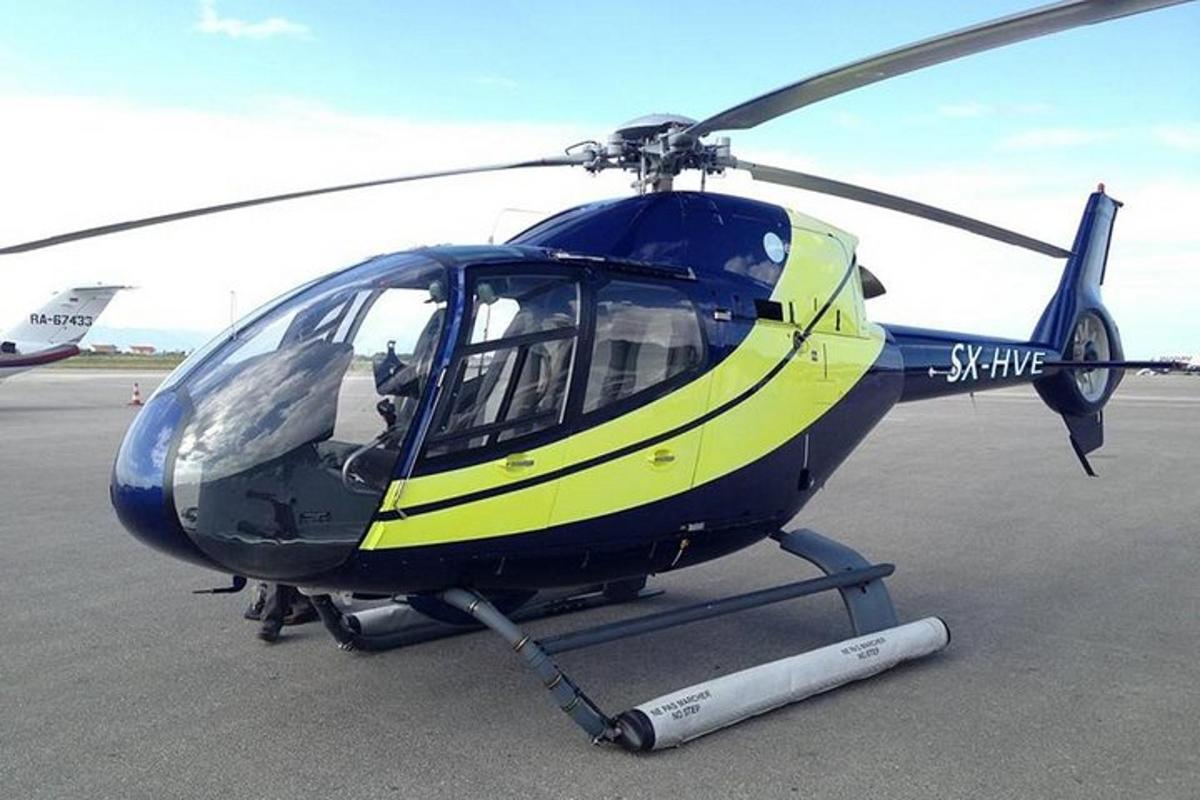 sebuah helikopter biru dan kuning diletakkan di atas landasan