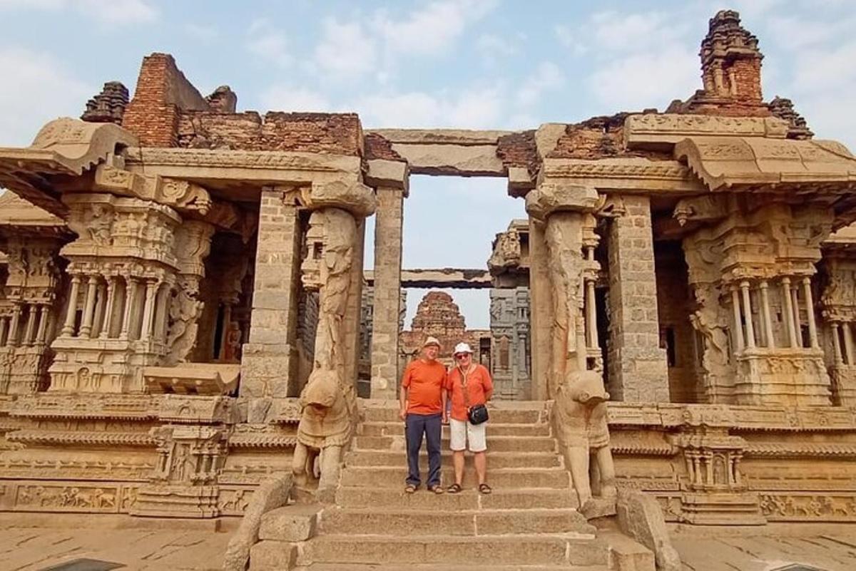 two people standing in front of a stone building