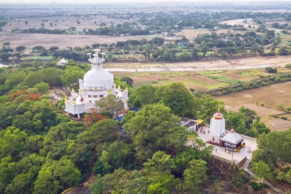 an aerial view of a white building with a tower