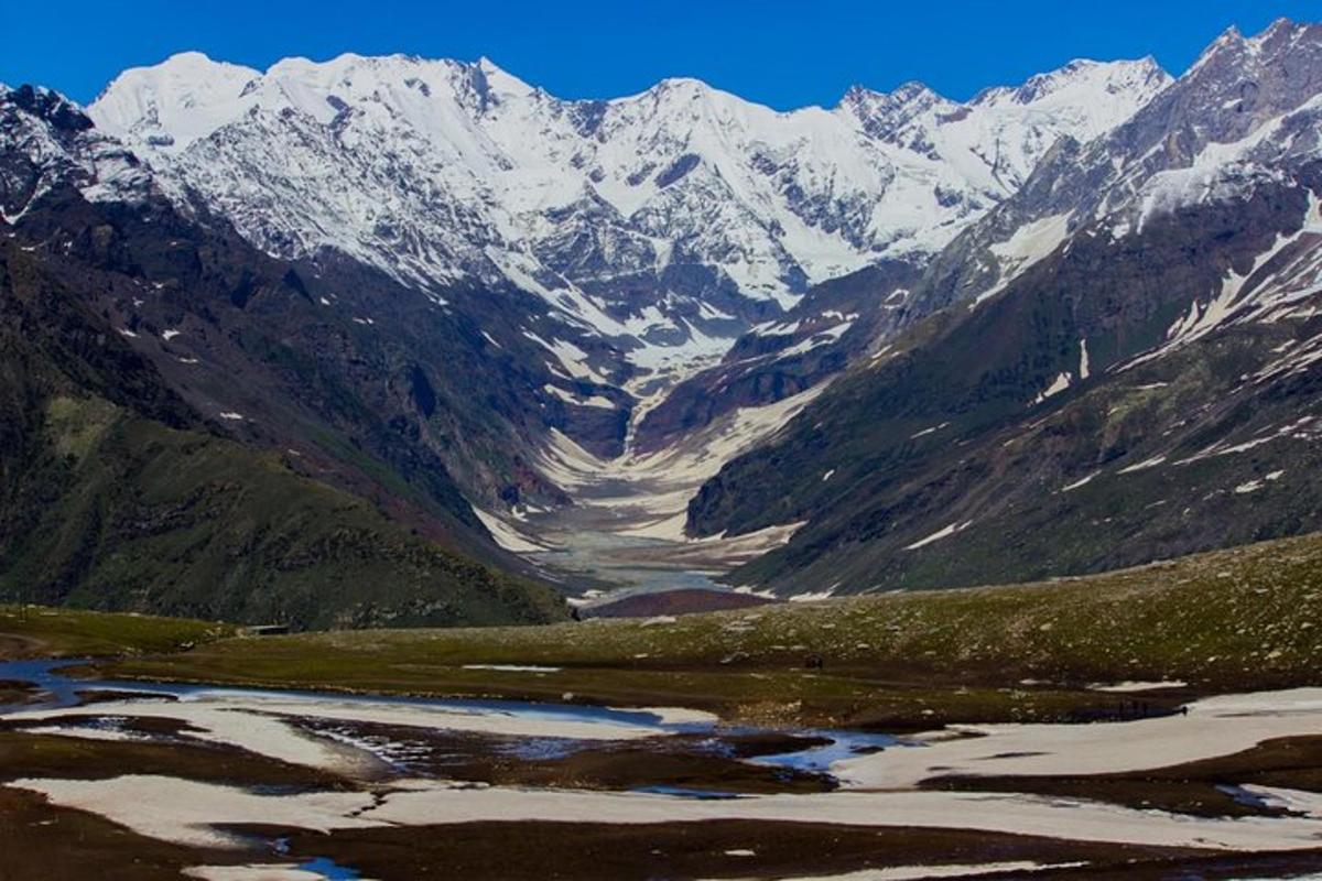 a view of a mountain range with snow covered mountains
