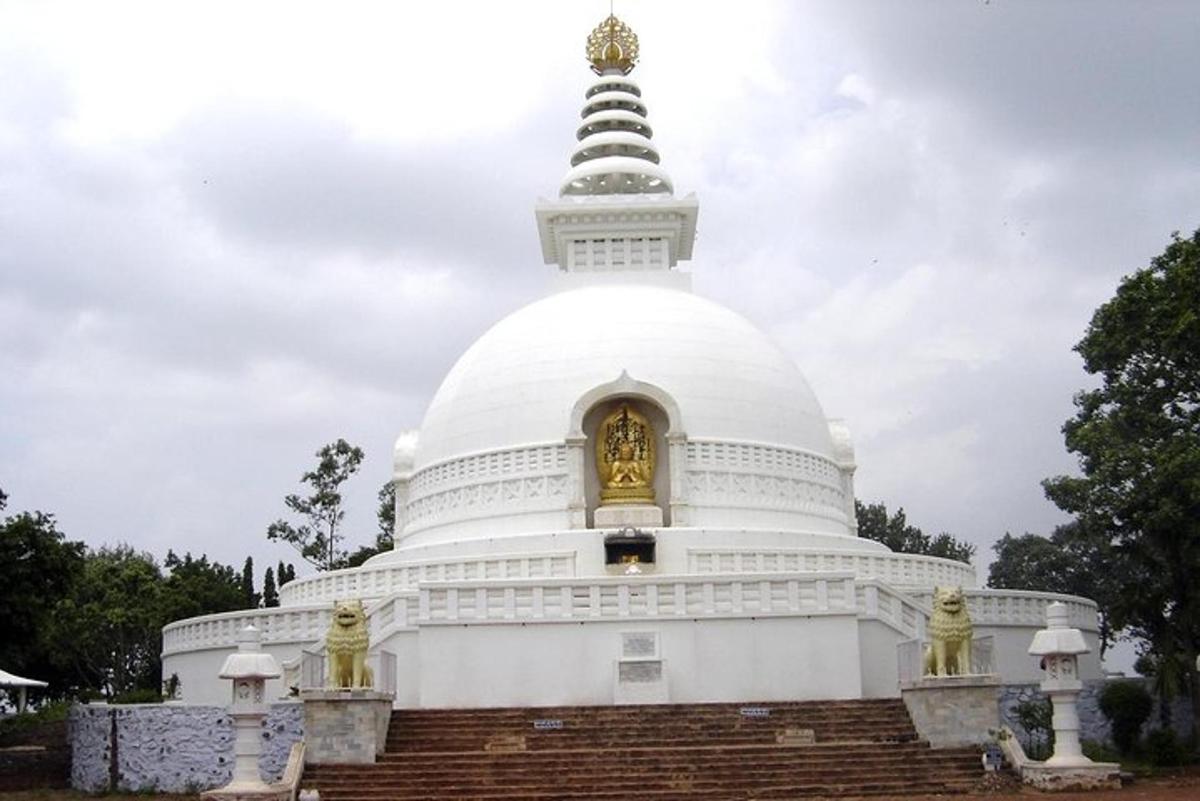 a large white temple with a gold bell