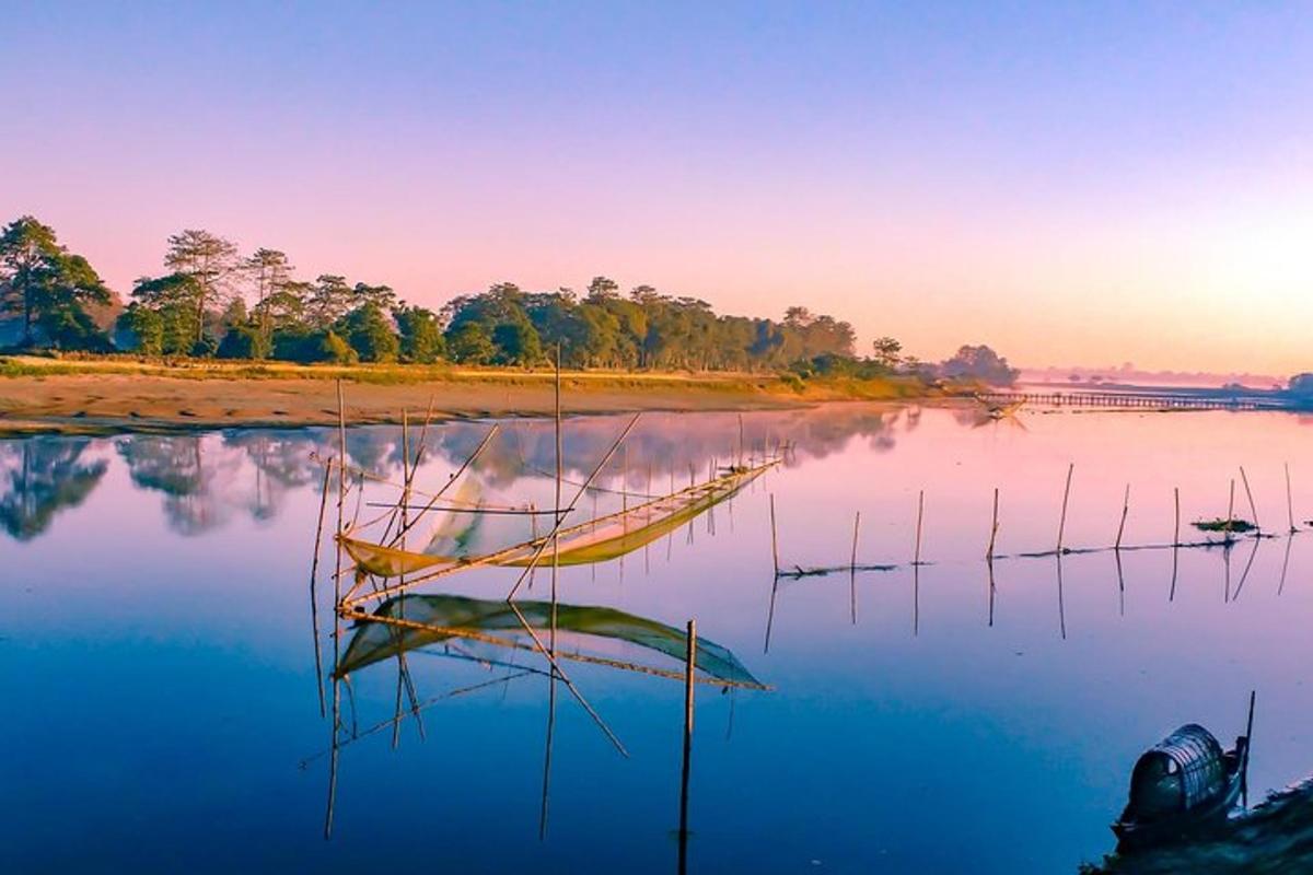 a boat sitting in the water at sunset