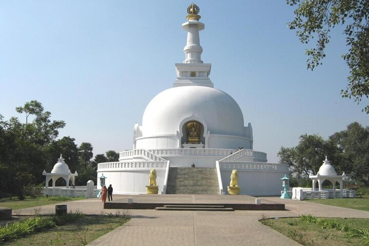a large white temple with people standing in front of it
