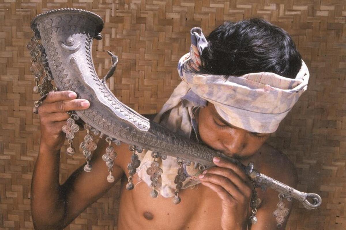 a man with a mask on his head holding a mirror