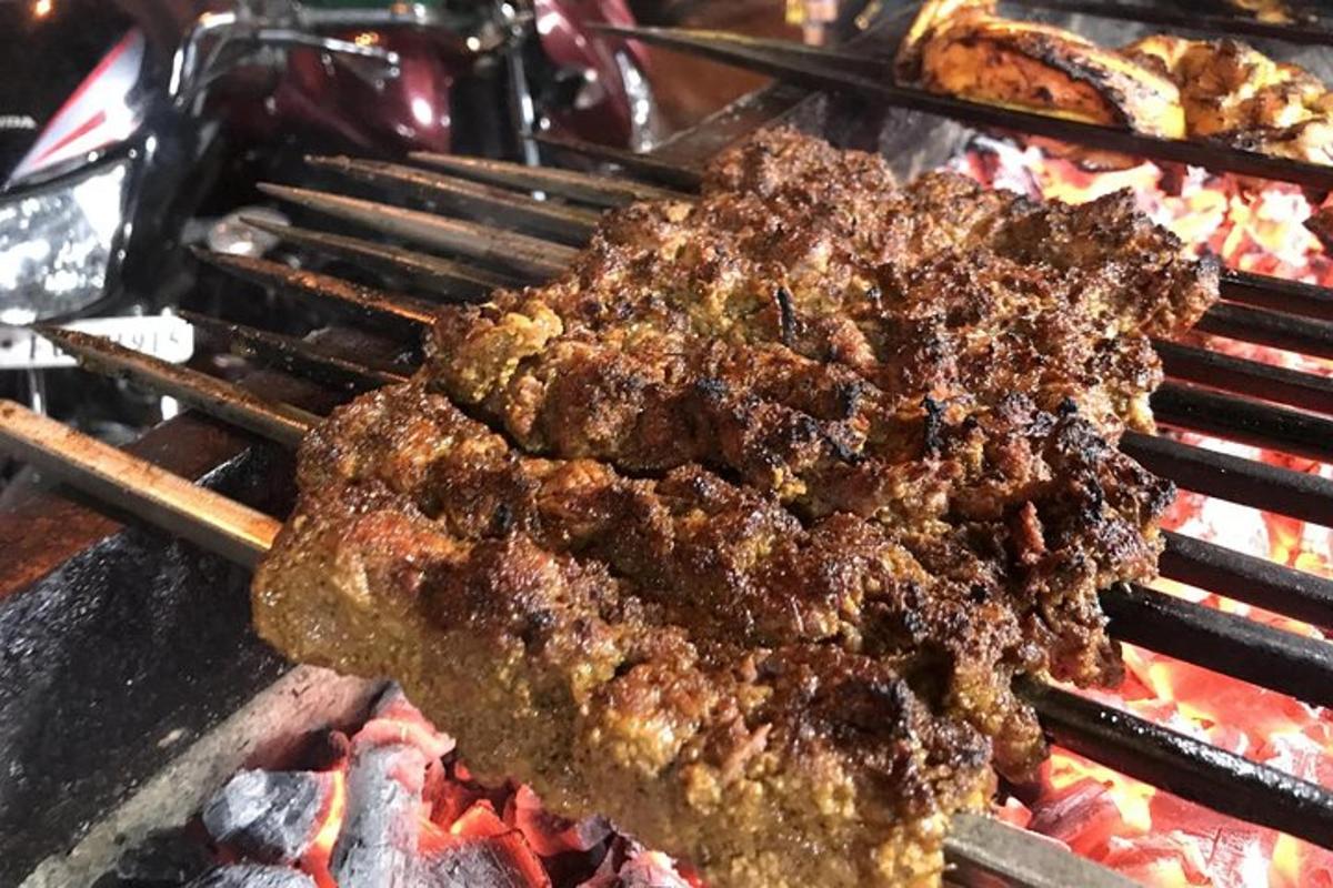 a bunch of meat cooking on a grill