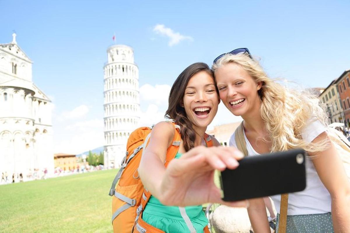 two women taking a picture of the leaning tower