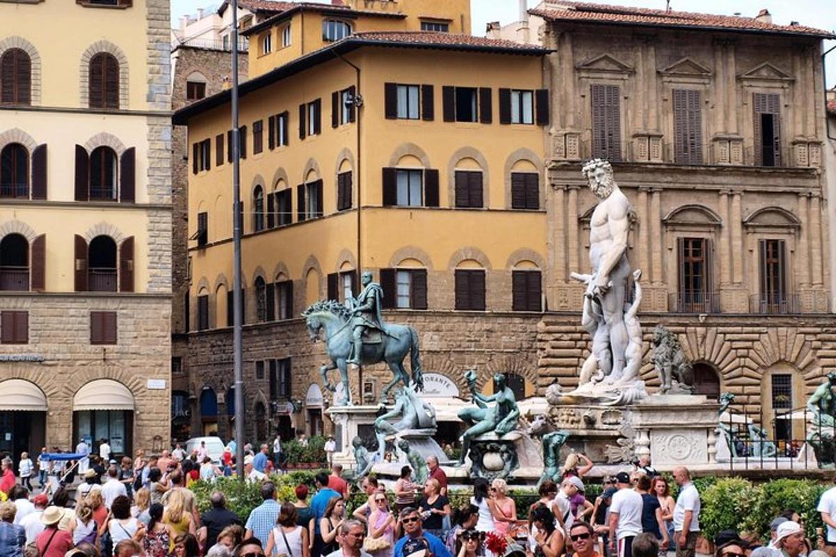 a crowd of people standing in front of a statue