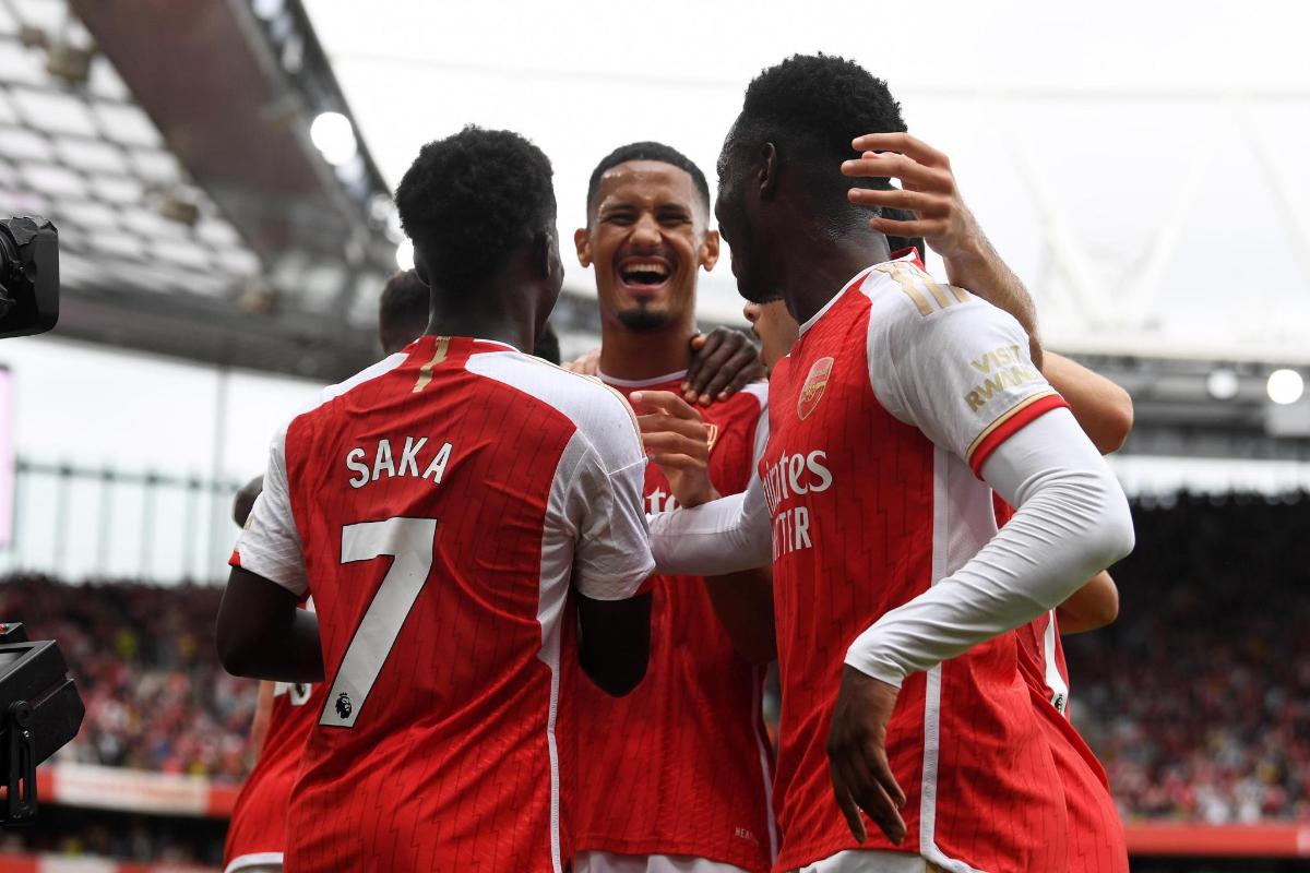 a group of three soccer players congratulate each other