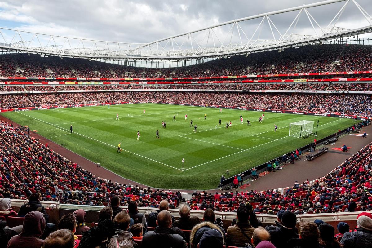 a crowd watches a soccer game in a stadium
