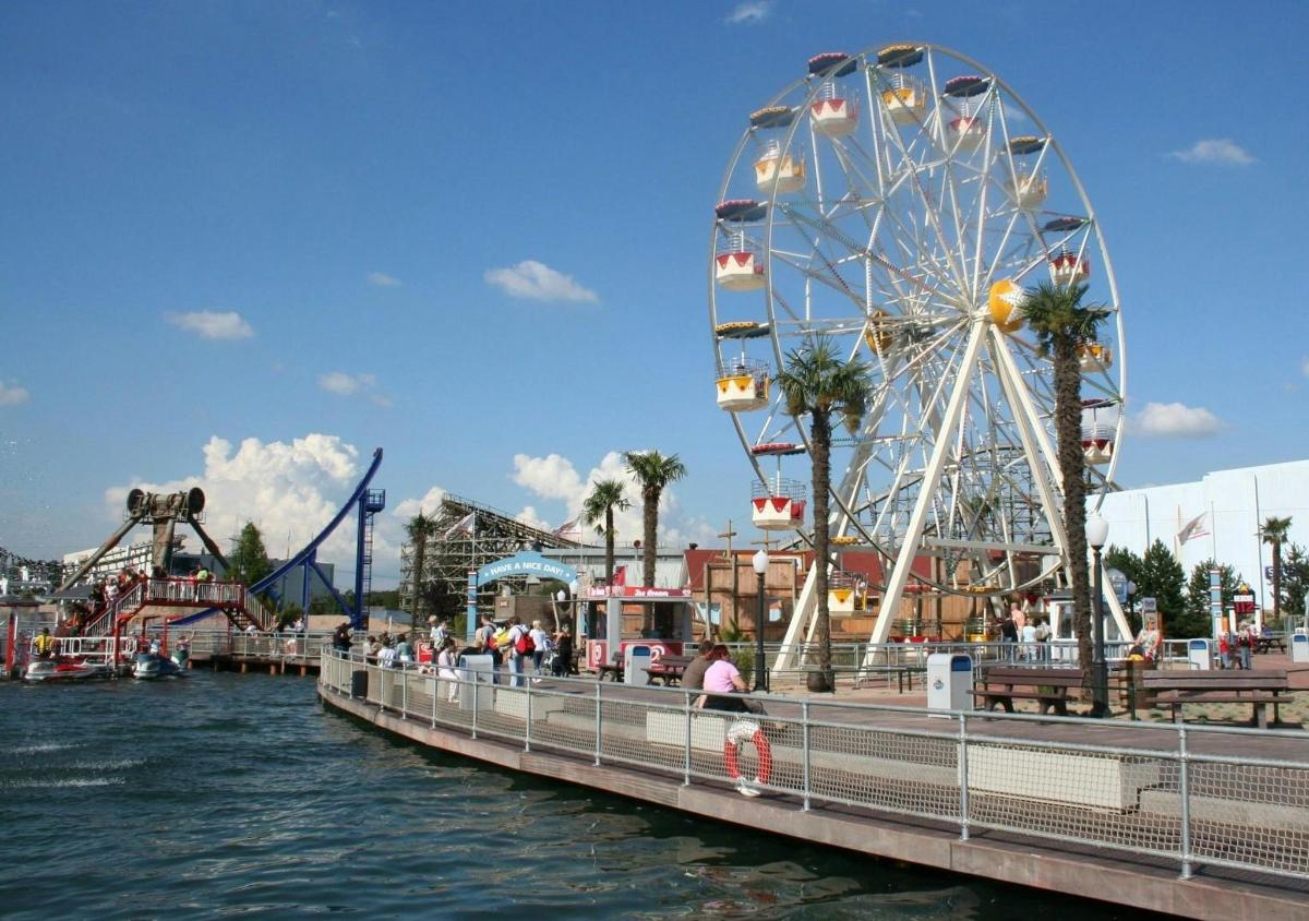 a ferris wheel on a pier next to the water