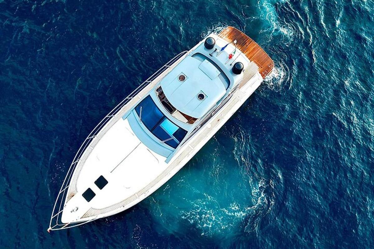 a white boat floating in the blue water