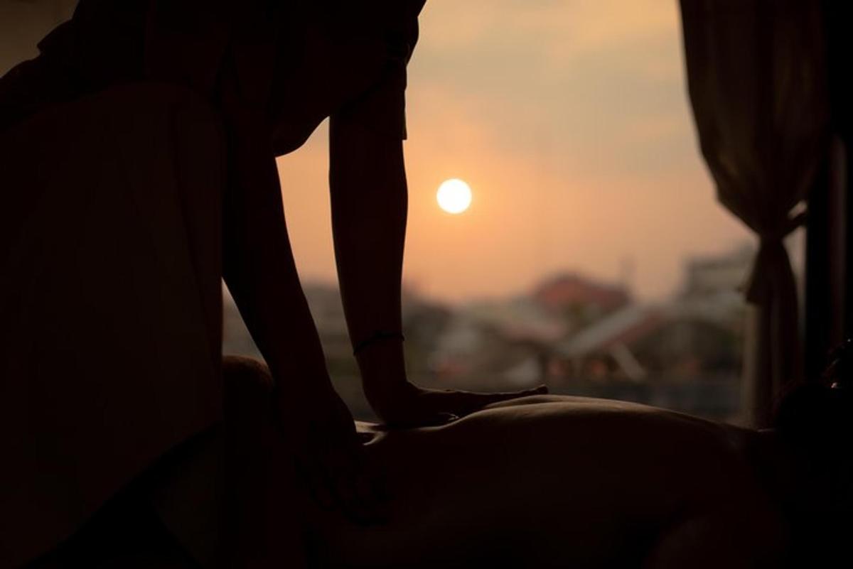 una persona in piedi sul davanzale di una finestra al tramonto